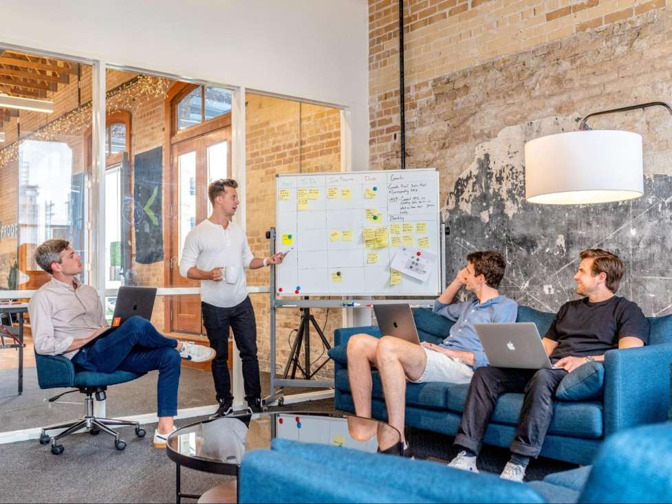 stock image of some people working on a presentation in an office