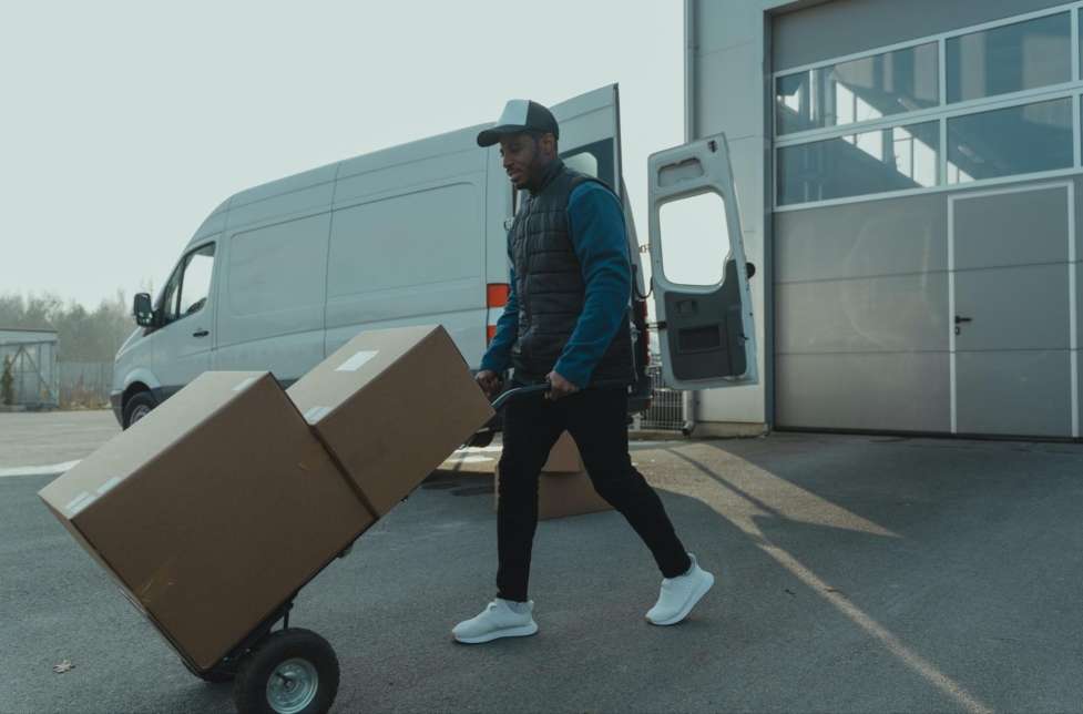 a stock image of a delivery man in a way to deliver some packages 