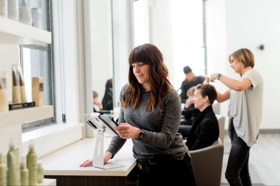 a beauty shop owner checking her daily calendar 