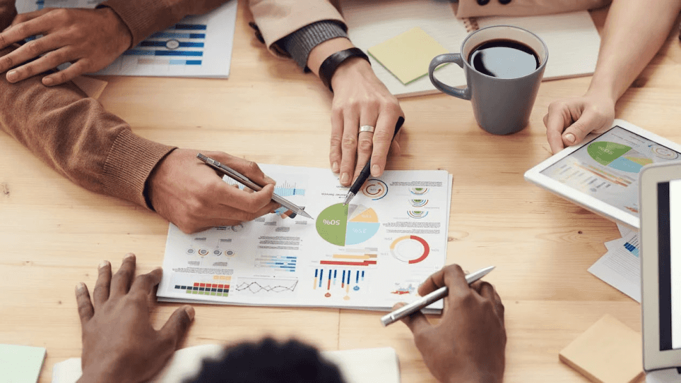 stock image of some team working together analysing some statistic data