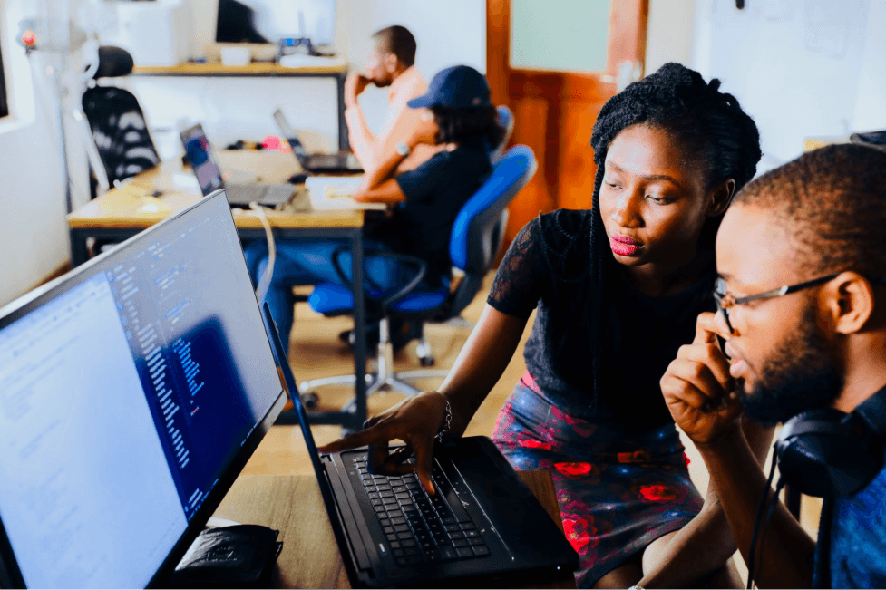 stock image of two people working together at the office 