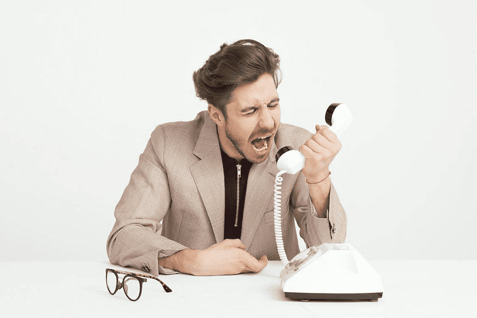 stock image of man shouting on the phone 